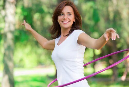 woman practicing hula hooping to show her strength