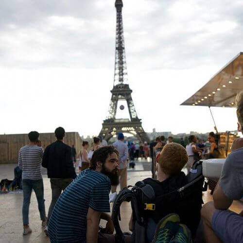 Kevan looking at the Eiffel tower with his friends