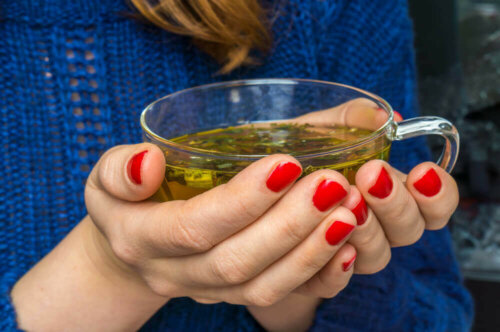 A person drinking some parsley and mint tea.