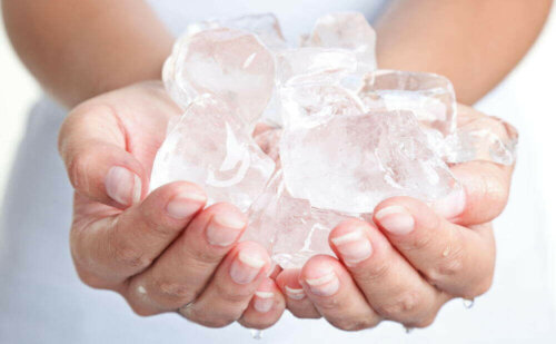 A person holding some ice cubes.