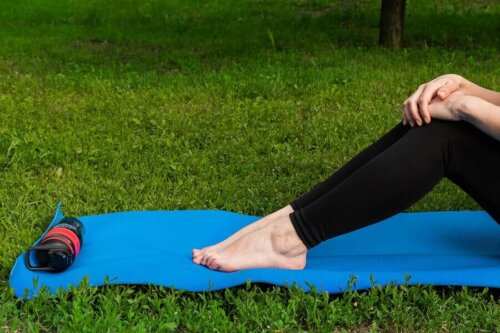 A person sitting on a yoga mat.