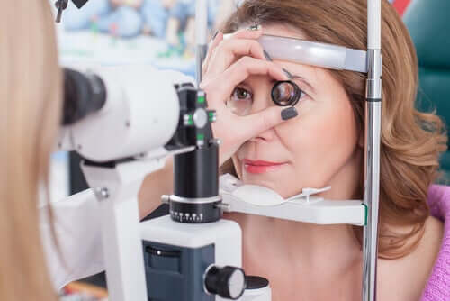 An optometrist examining a woman's eye.