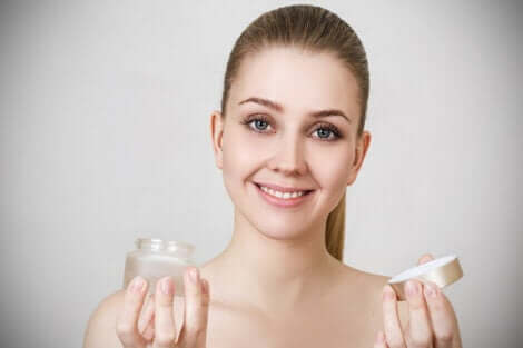 A woman applying a face cream.