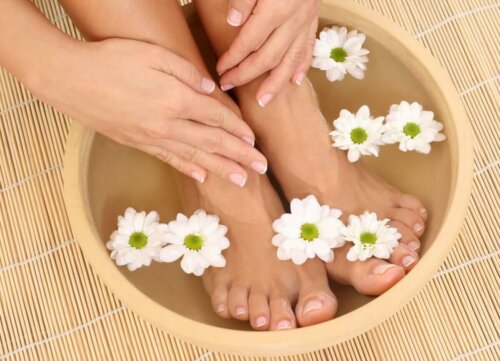 A woman soaking her feet in salt water, one of the natural blister remedies.