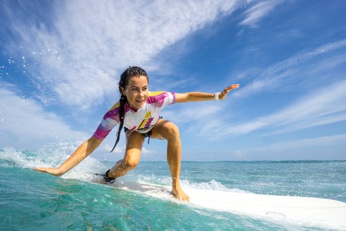 A woman surfing on the sea.
