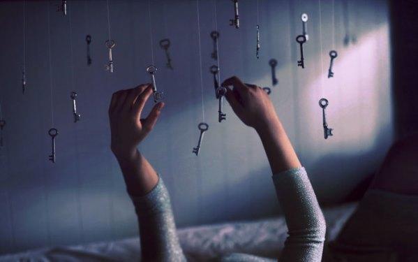Person touching dangling keys from ceiling