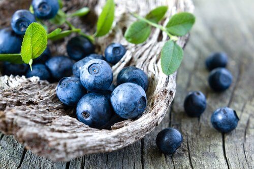 Some blueberries on wood.