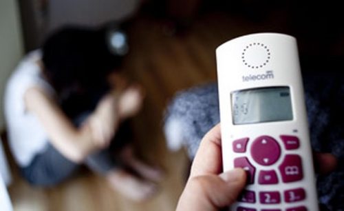 A woman about to call the police due to abuse.