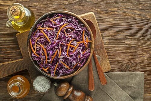A bowl of salad on a cutting board.