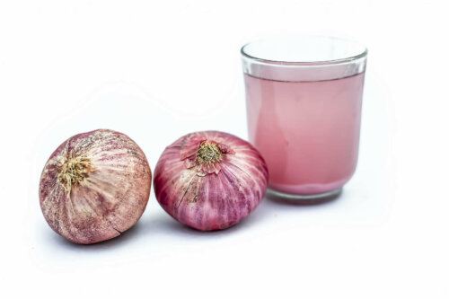 A glass of red onion juice.