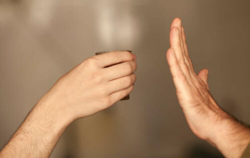 A person rejecting an alcoholic beverage because they worsen migraines.