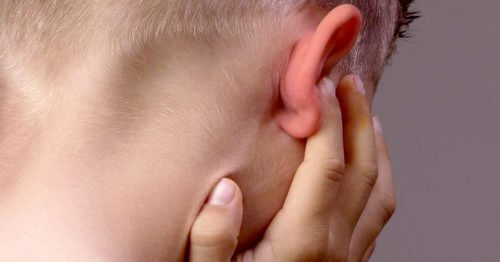 Back of child's head plugging ear
