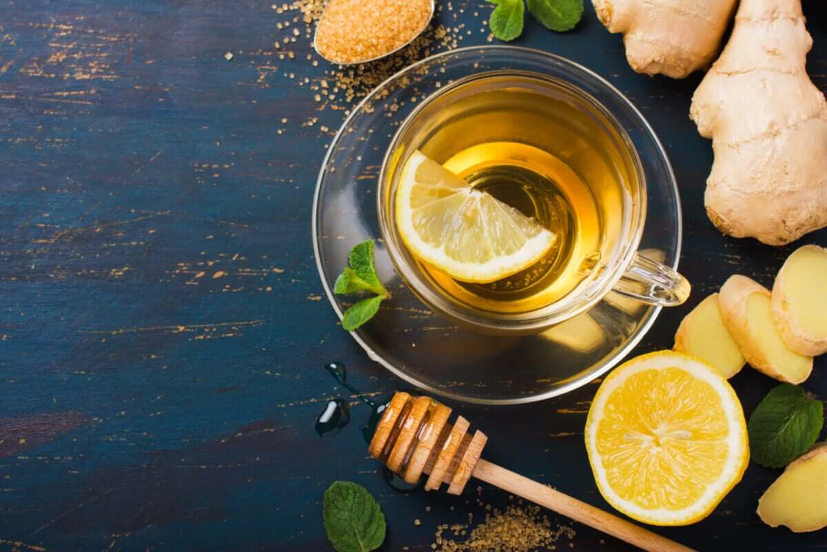 A cup of green tea with ginger and lemon.