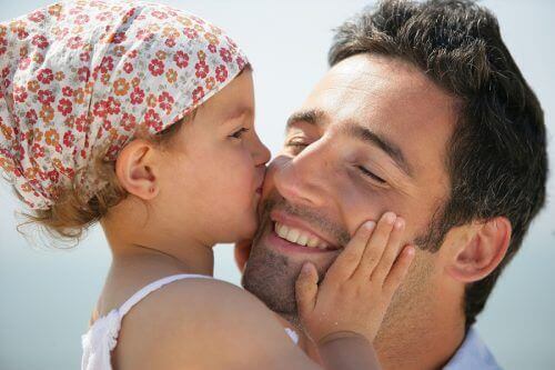 Daughter kissing father on cheek strong woman