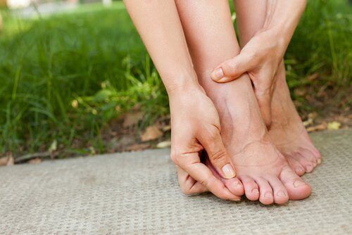 Woman holding toe