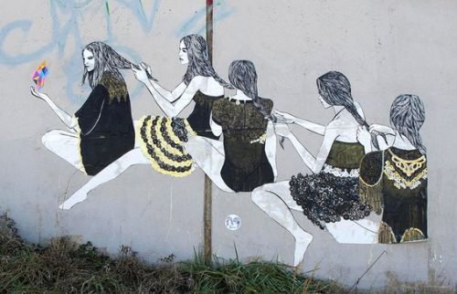 A row of women braiding hair.