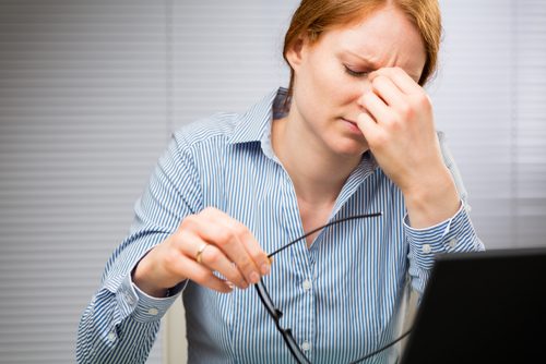 A woman with a headache.