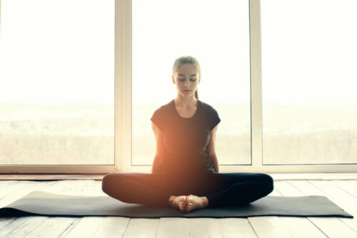 A woman meditating.