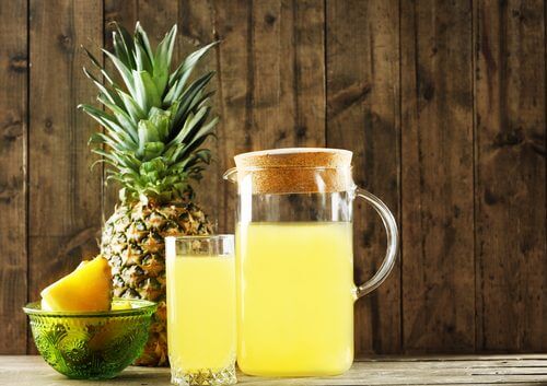 A jar and a glass of fermented pineapple juice