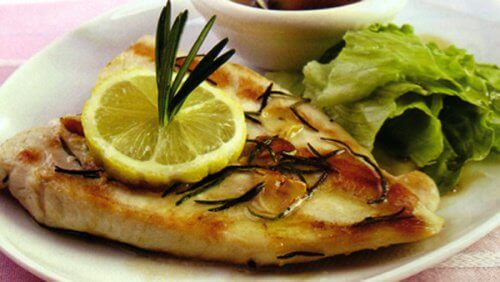 A plate of baked fish and salad