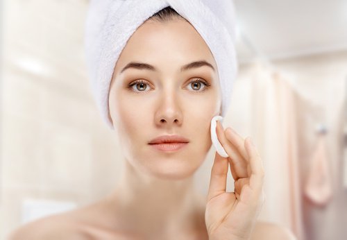 Woman cleaning her face.