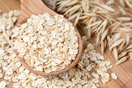 A wooden spoon with oats
