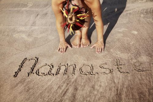 Namaste written in the sand