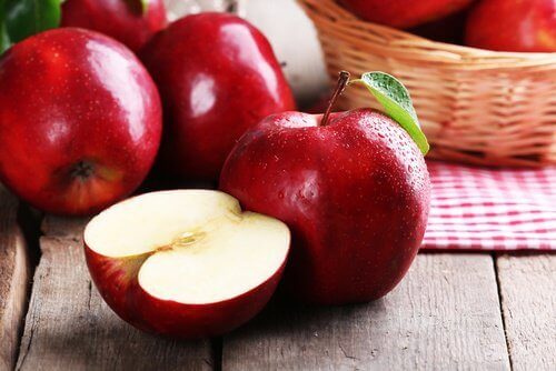 Red apples on a wooden surface