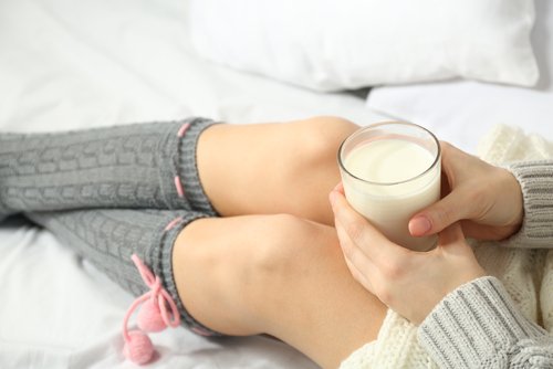 Woman holding a glass of milk