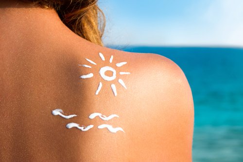 sunscreen on girl's back