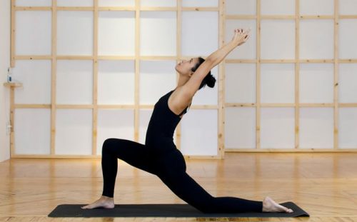 A woman doing the dove pose.
