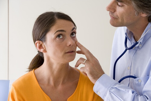A doctor checking out a patient with pale skin.
