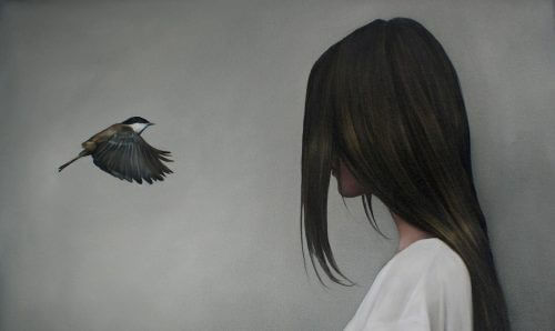 a sad woman looking at a black bird