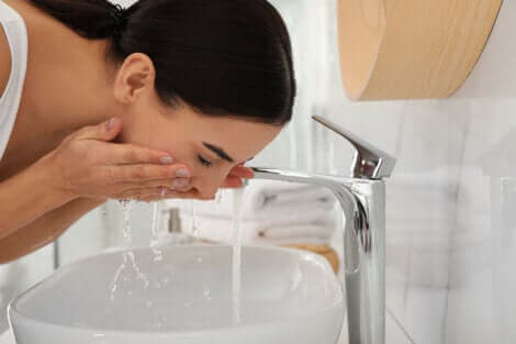 A woman washing her face.