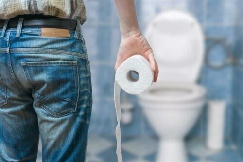 A man holding a roll of toiler paper.