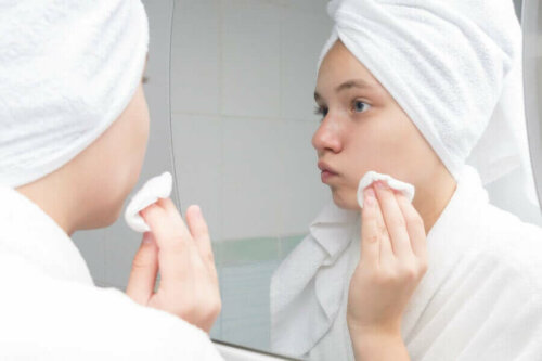 A woman applying a substance on her face.