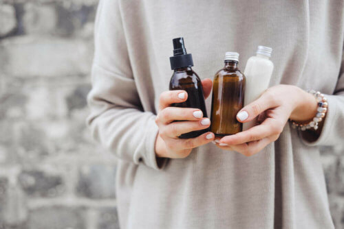 A woman holding essential oils.