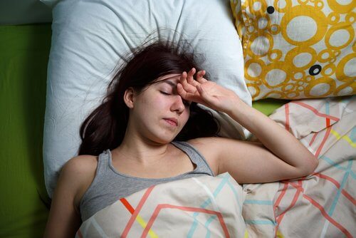 A woman laying in bed.