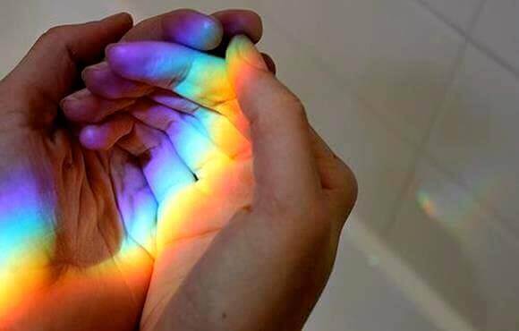 A person with a rainbow in their hands.