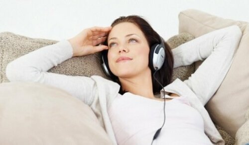 A woman relaxing listening to music.