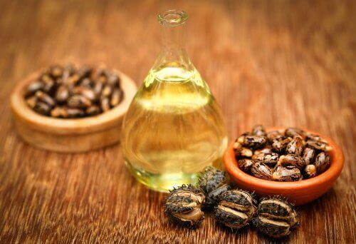 Castor oil vitamin e help strengthen nails bottle and bowls on wooden table