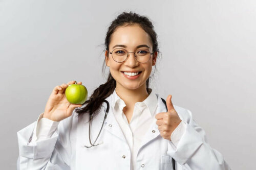 A woman holding an apple.