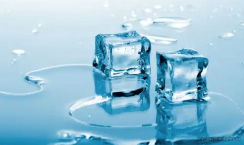 Some ice cubes melting on a surface.