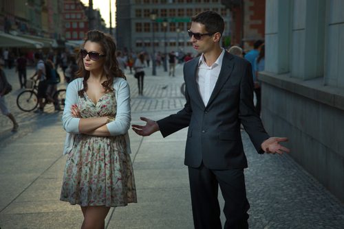 A couple arguing in the street.