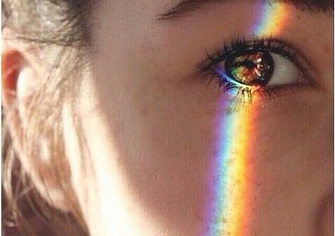 woman's eye with a rainbow over it