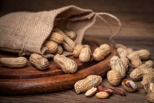 Peanuts are edible seeds peanuts on a cutting board with shells