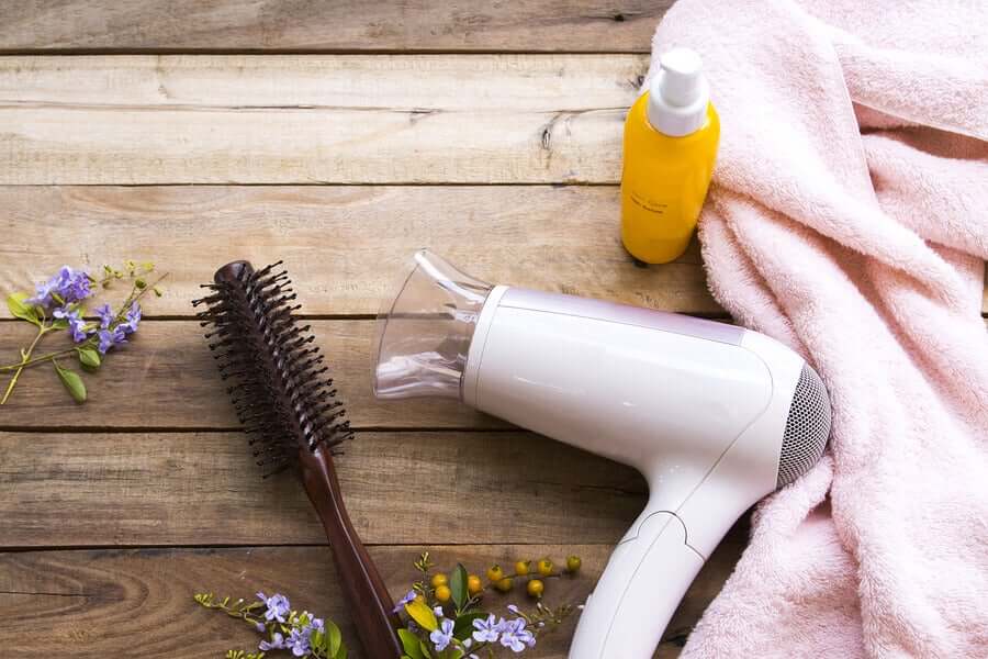 A hairdryer, a brush, and a towel.