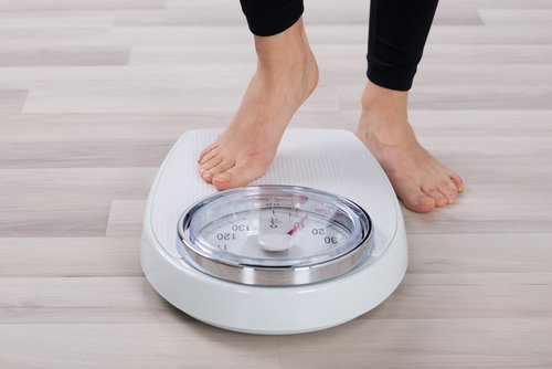 A person weighing themselves.