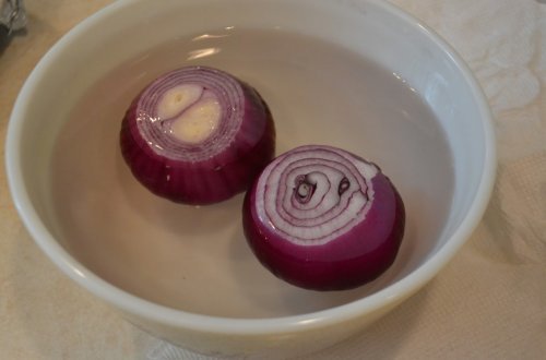 Some onions in a bowl of water.