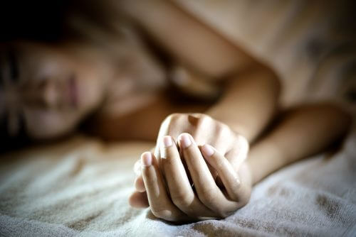 woman lying in bed sad